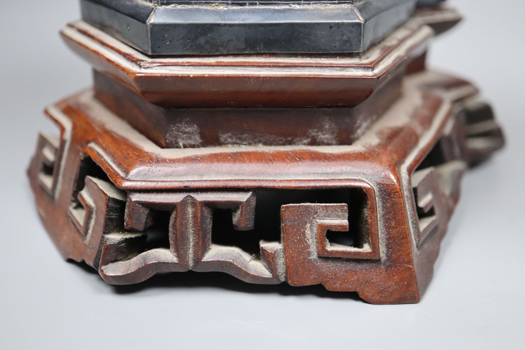 An early 20th century Chinese white metal miniature model of a pagoda, on a hardwood base, model 21.4cm, 11.5oz,